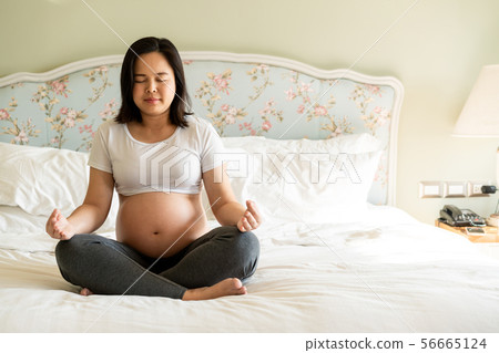 Happy pregnant woman and expecting baby at home. 56665124