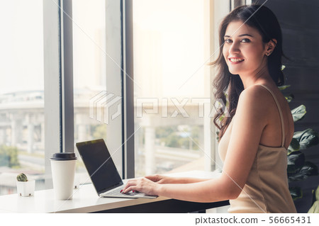 Business woman using laptop computer at cafe. Business woman using laptop computer at cafe. 56665431