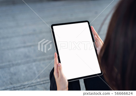Hand holding digital tablet blank screen. mockup 56666624