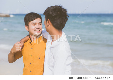 Homosexual young asian couple standing on beach Homosexual young asian couple standing on beach 56668347