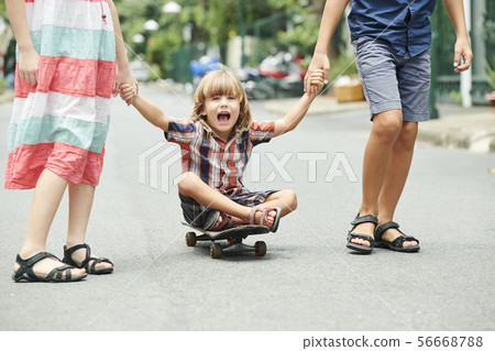 Happy excited kid on skateboard Happy excited kid on skateboard 56668788