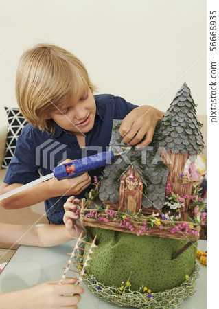 Boy assembling fairytale castle 56668935