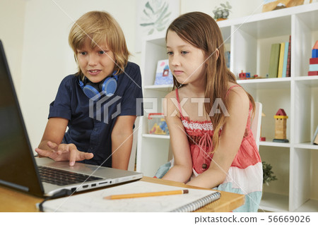 Preteen boy helping classmate 56669026