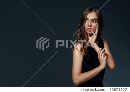 woman with perfect skin and long hair in black dress 56671807