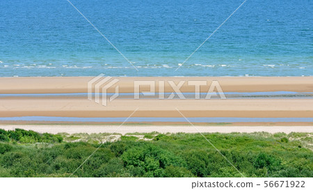 Long calm beach with blue cloudy sky. Omaha Beach. Long calm beach with blue cloudy sky. Omaha Beach. 56671922
