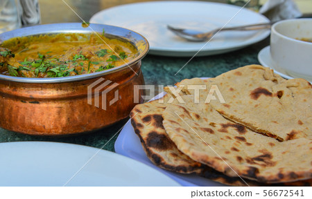 Butter chicken curry with Indian bread (roti) Butter chicken curry with Indian bread (roti) 56672541