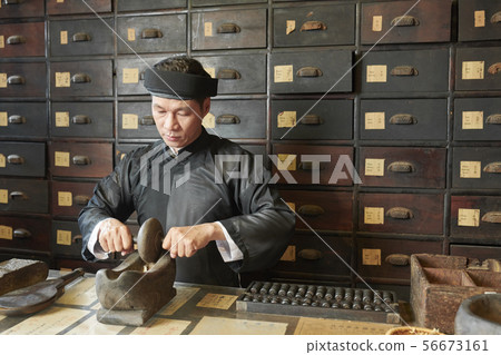 Medicine practitioner pulverizing medicines Medicine practitioner pulverizing medicines 56673161