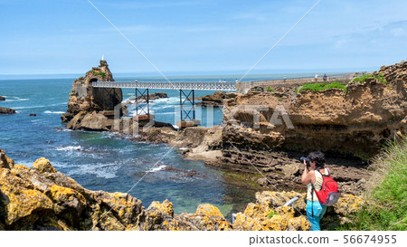 woman take picture from Rock of the Virgin, 56674955