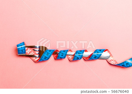 Top view of obesity concept with fork wrapped in Top view of obesity concept with fork wrapped in 56676040