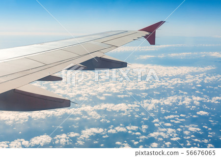 Aircraft wing on the clouds, flies on the 56676065
