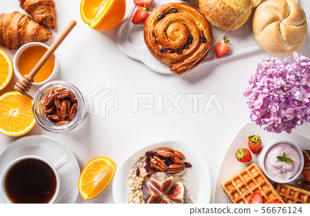 Breakfast table with oatmeal, waffles, croissants 56676124