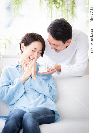 Surprise couple married couple giving present 56677333