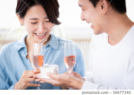 Surprise couple married couple giving present 56677340
