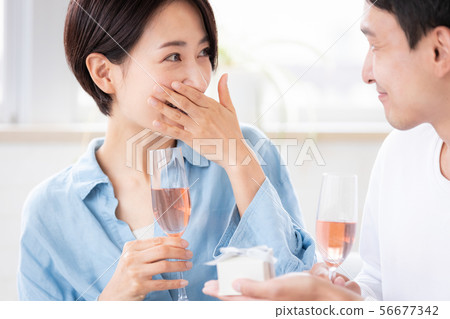 Surprise couple married couple giving present 56677342