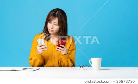 Women comparing smartphones Women comparing smartphones 56678750