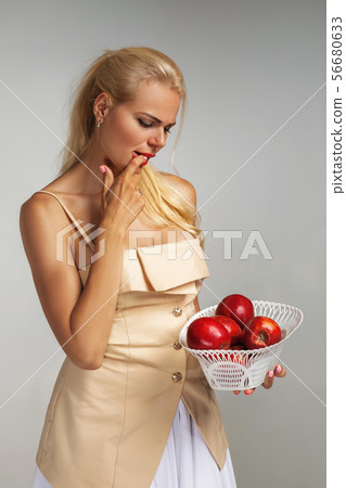 young woman holding red apple 56680633