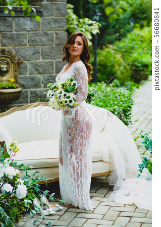 Young sexy bride posing with bridal bouquet 56680841