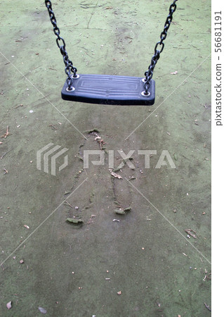 Park swing with damaged safety surface Park swing with damaged safety surface 56681191
