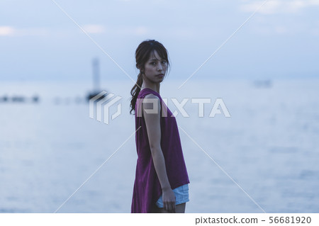 Woman in the sea at sunset Woman in the sea at sunset 56681920