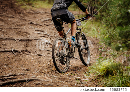 male cyclist riding uphill male cyclist riding uphill 56683753