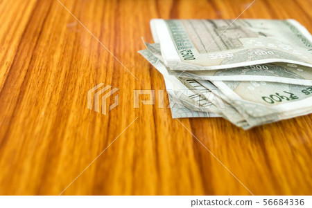 Stolen money india rupee note laying on table.  56684336
