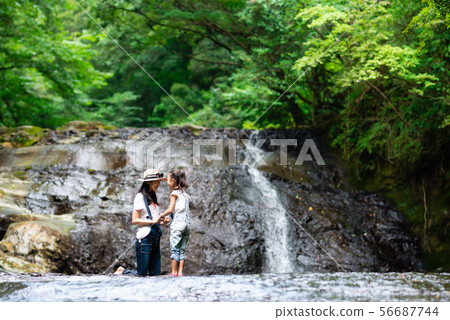 Mother and kid playing in waterfall 56687744