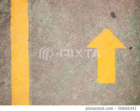 Yellow arrow painting on gray concrete background Yellow arrow painting on gray concrete background 56688341