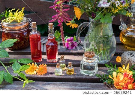 Bottles of essential oil with a mix of medicinal Bottles of essential oil with a mix of medicinal 56689241