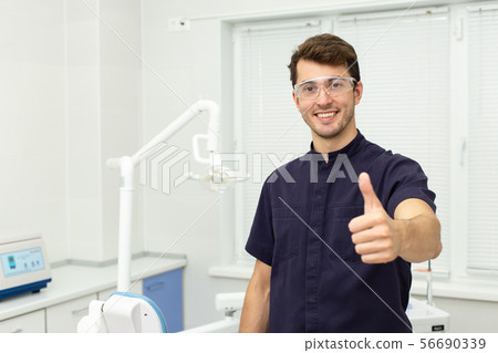 Dental polymerization lamp with UV light and laser. Stomatological instrument in the dentist clinic 56690339