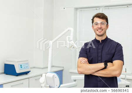 Dental polymerization lamp with UV light and laser. Stomatological instrument in the dentist clinic 56690341