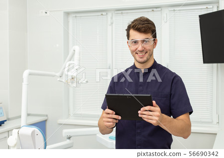 Dental polymerization lamp with UV light and laser. Stomatological instrument in the dentist clinic 56690342