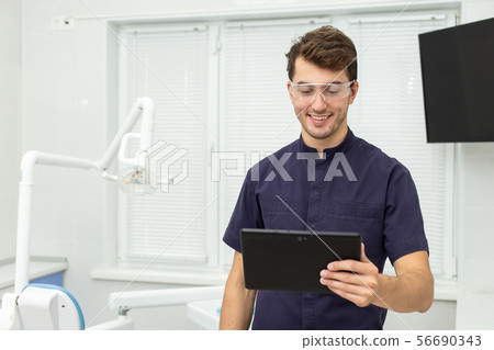 Dental polymerization lamp with UV light and laser. Stomatological instrument in the dentist clinic 56690343