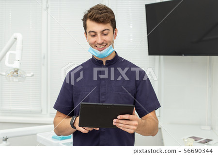 Dental polymerization lamp with UV light and laser. Stomatological instrument in the dentist clinic 56690344