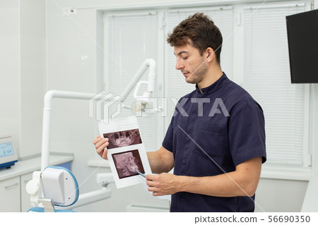 Dental polymerization lamp with UV light and laser. Stomatological instrument in the dentist clinic 56690350