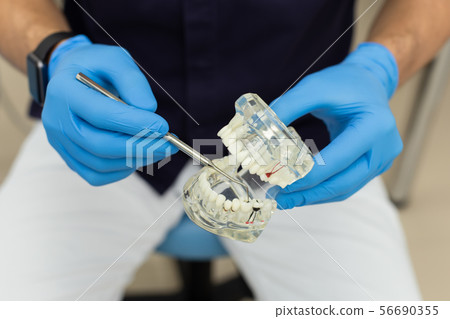 Dental polymerization lamp with UV light and laser. Stomatological instrument in the dentist clinic 56690355