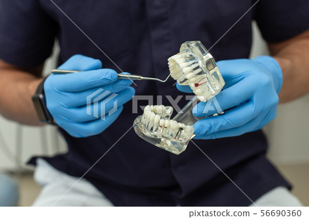 Dental polymerization lamp with UV light and laser. Stomatological instrument in the dentist clinic 56690360