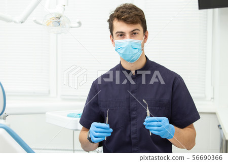 Dental polymerization lamp with UV light and laser. Stomatological instrument in the dentist clinic 56690366