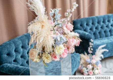 Flower arrangement. Beautiful and exquisite decoration of the wedding celebration. Blue sofa, Luxury Flower arrangement. Beautiful and exquisite decoration of the wedding celebration. Blue sofa, Luxury 56690828