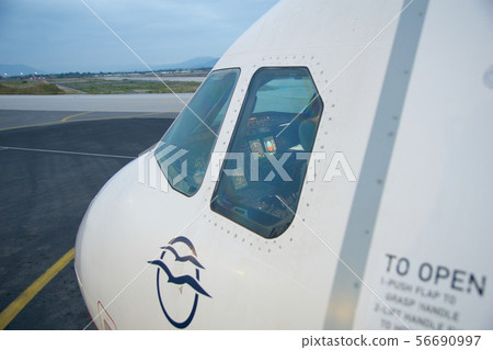 THESSALONIKI, GREECE - OCTOBER 15, 2016: An airplane at the boarding gate of airport, jetway and THESSALONIKI, GREECE - OCTOBER 15, 2016: An airplane at the boarding gate of airport, jetway and 56690997