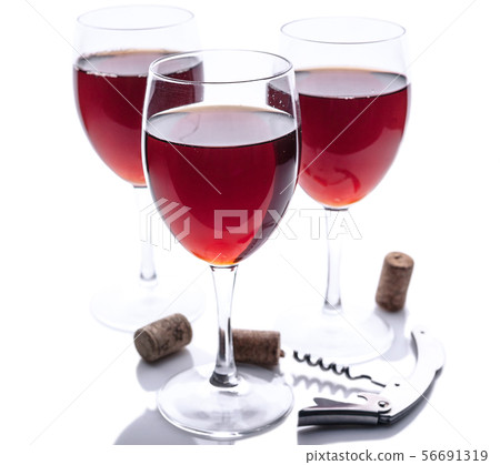 Three glasses with red wine, corkscrew and cork  56691319