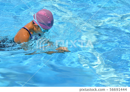 Girl swimming in pool (breaststroke) 56691444