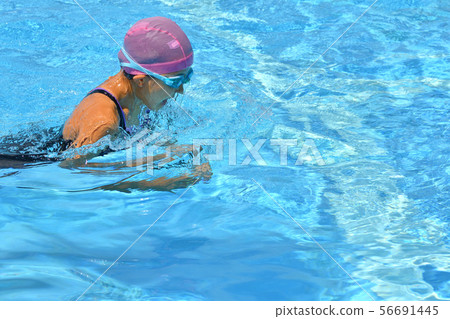 Girl swimming in pool (breaststroke) 56691445