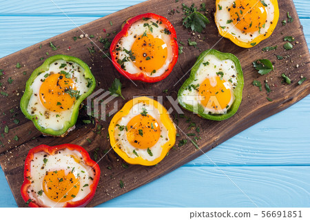 Yellow , red and green pepper with fried eggs 56691851