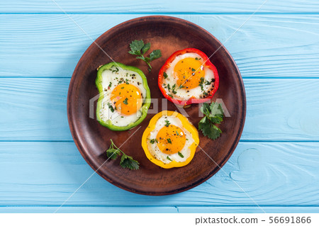 Yellow , red and green pepper with fried eggs Yellow , red and green pepper with fried eggs 56691866