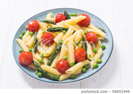 Penne pasta salad with asparagus , tomatoes and 56691946