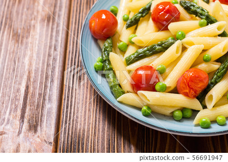 Penne pasta salad with asparagus , tomatoes and 56691947