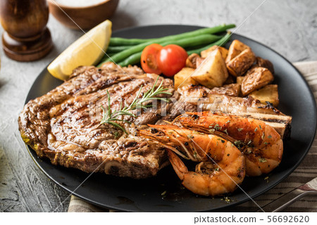 surf and turf, ribeye steak and grilled prawn 56692620