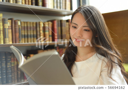 A woman reading a book A woman reading a book 56694162