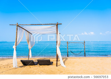 Chair umbrella and lounge on the beautiful beach sea ocean on sky Chair umbrella and lounge on the beautiful beach sea ocean on sky 56697053