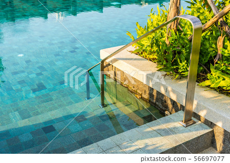 Outdoor swimming pool with stair ladder around there 56697077